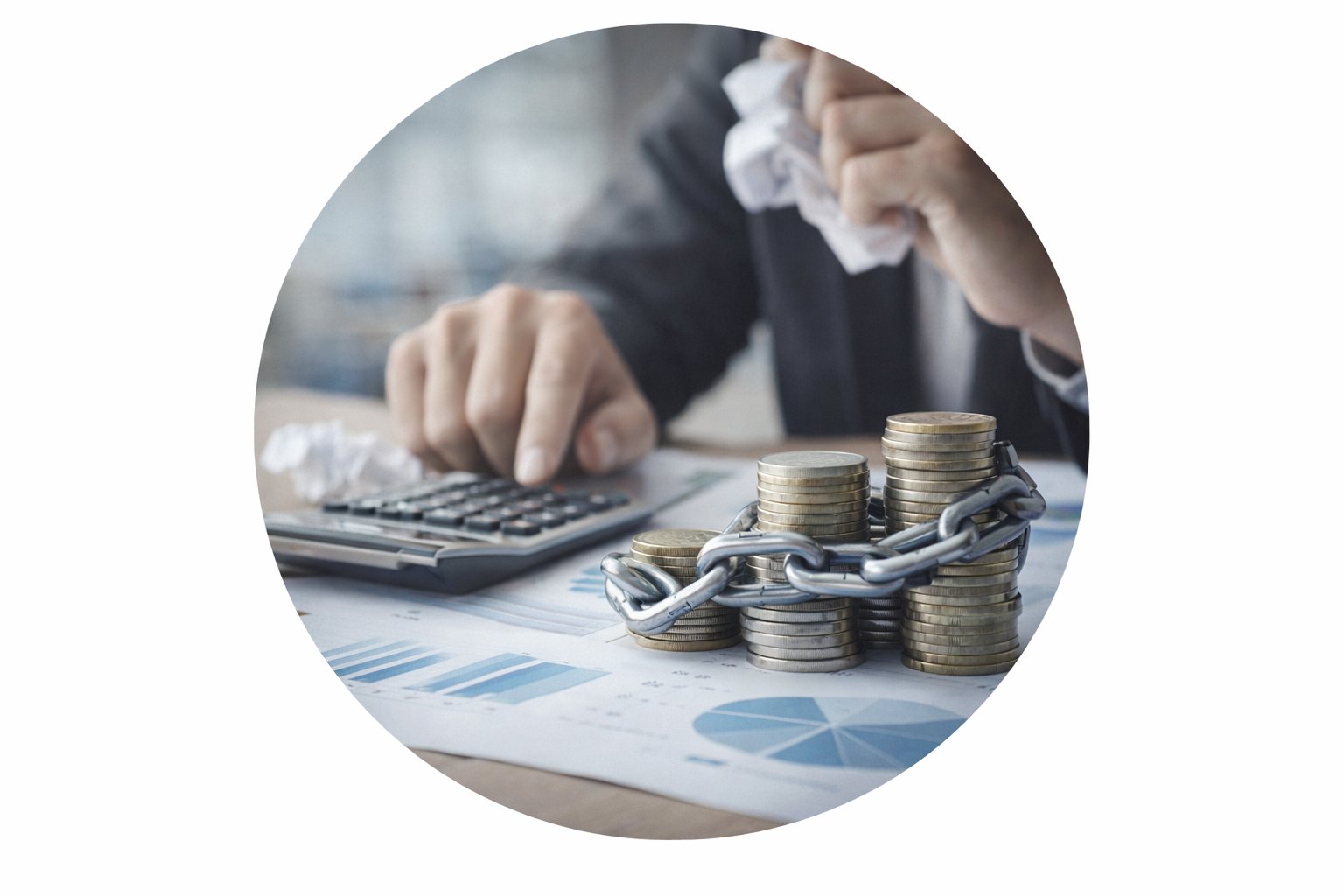 A person using a calculator beside stacks of coins wrapped in chains over financial charts