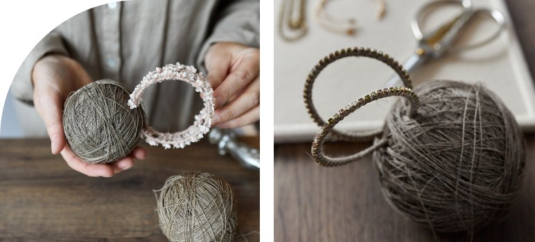 Hands holding a linen thread ball with a beaded bracelet beside a rhinestone bangle