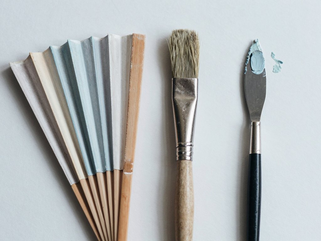 Pastel sticks, a dry brush and oil paint on a palette knife arranged on paper