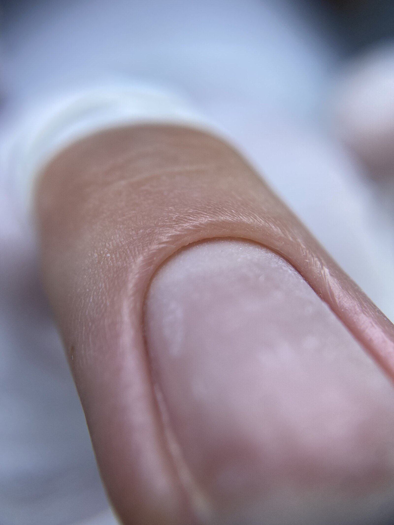 Macro close-up of a natural nail and cuticle